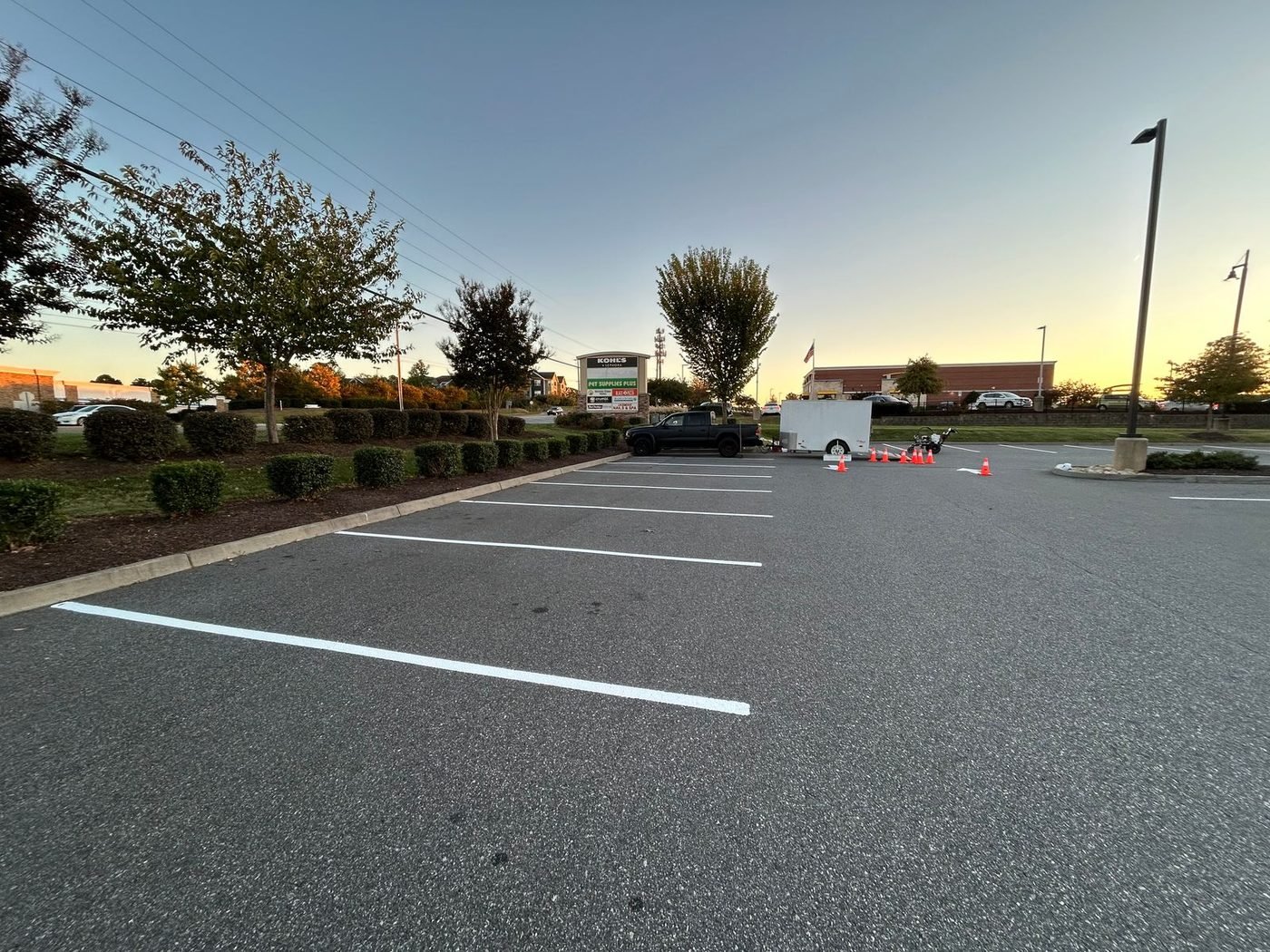 Fresh parking lot striping laid out in front of a retail building