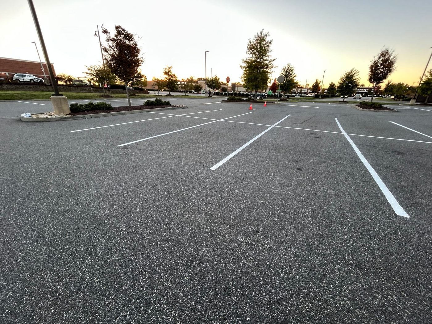 Wide view of a commercial parking lot with newly repainted stall lines
