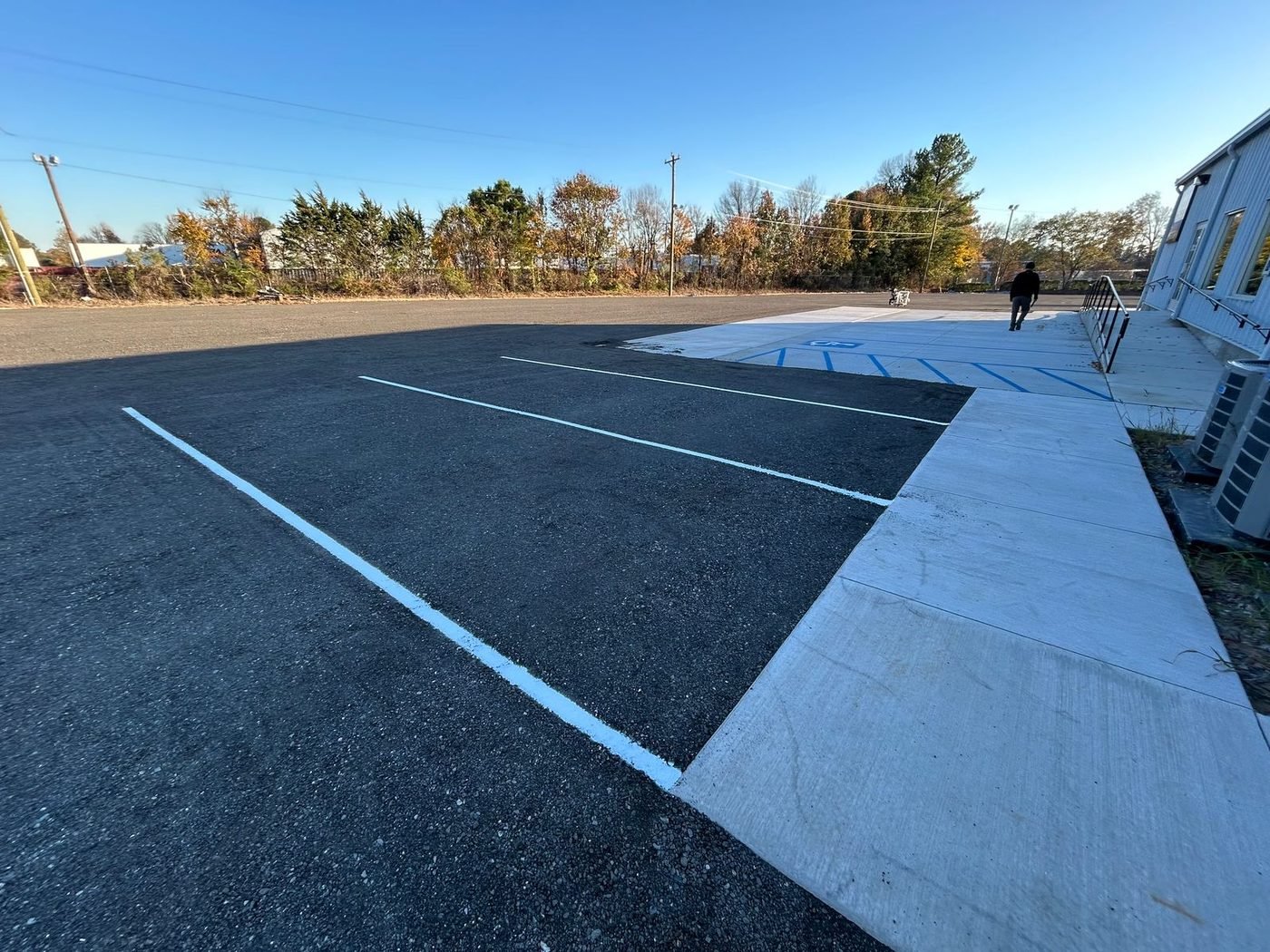 Wide painted hatch marking separating traffic areas on a parking lot