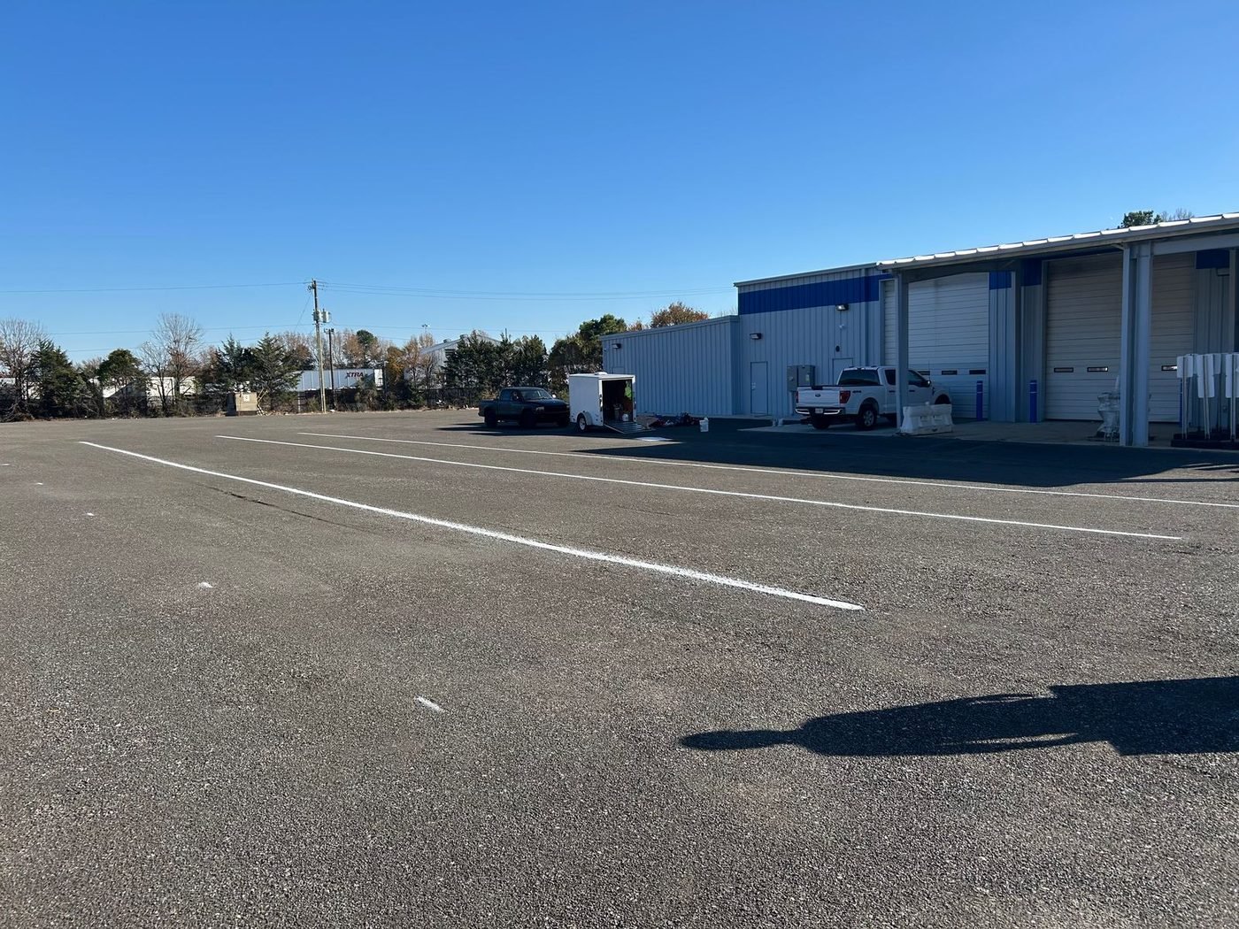 Parking stalls freshly marked outside a warehouse and industrial building